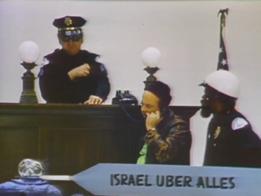 Screencap from first episode of "Turn-On" (1969) showing a banner being pulled across the screen reading "Israel Uber Alles"